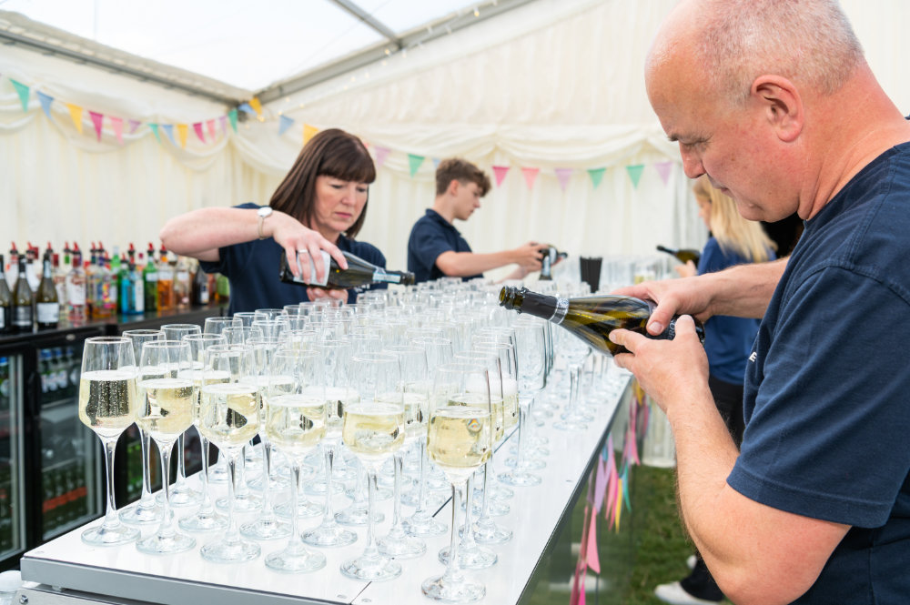 Neptune Bars staff pouring bubbly