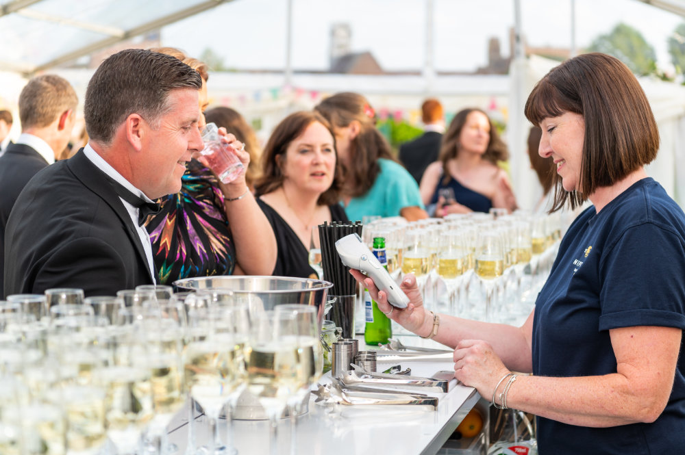 Neptune Bars taking payment from smiling guests