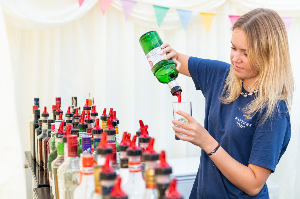Neptune Bars girl pouring gin